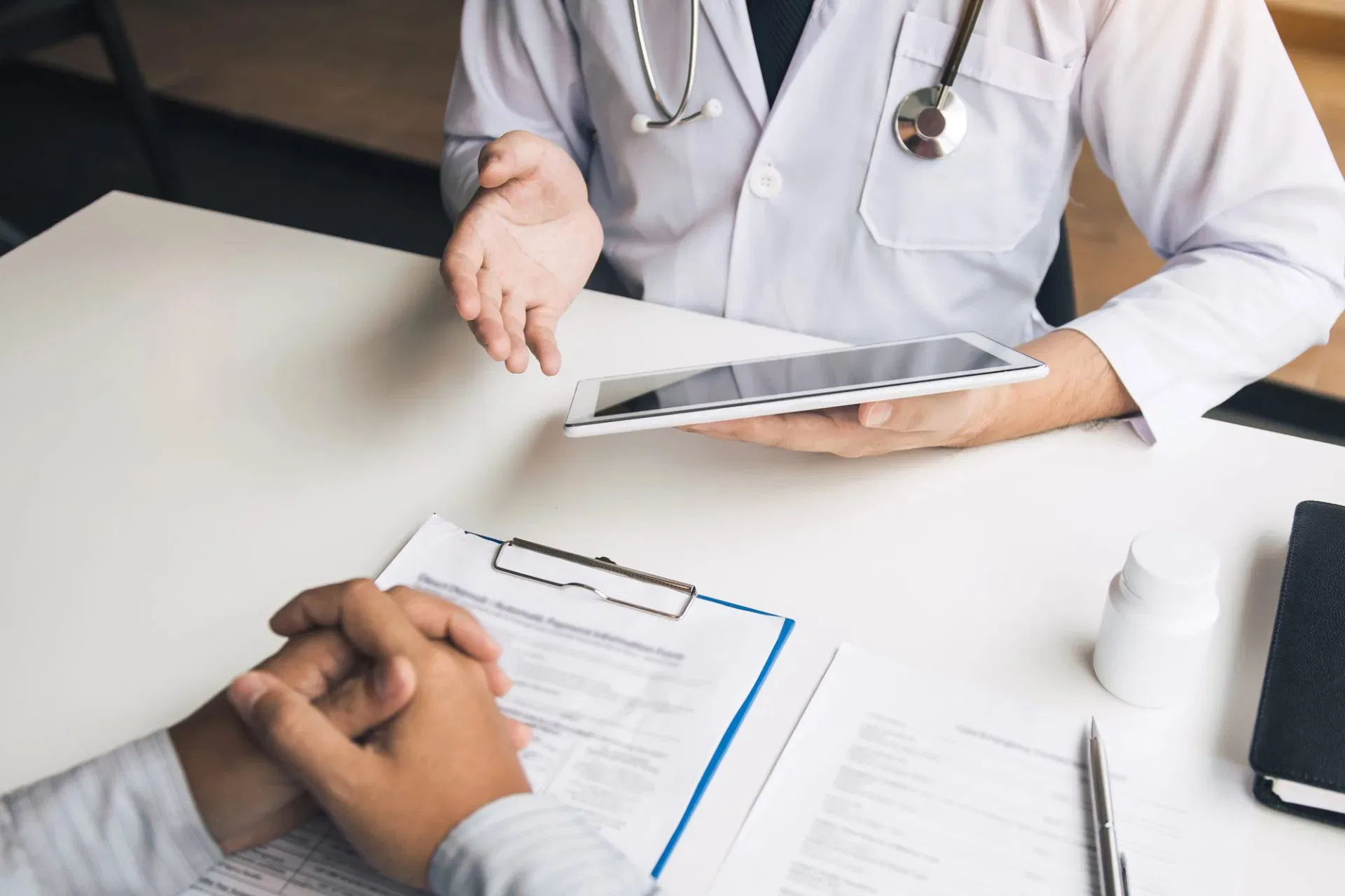 photo of a doctor and patient discussion medical reports for the patient