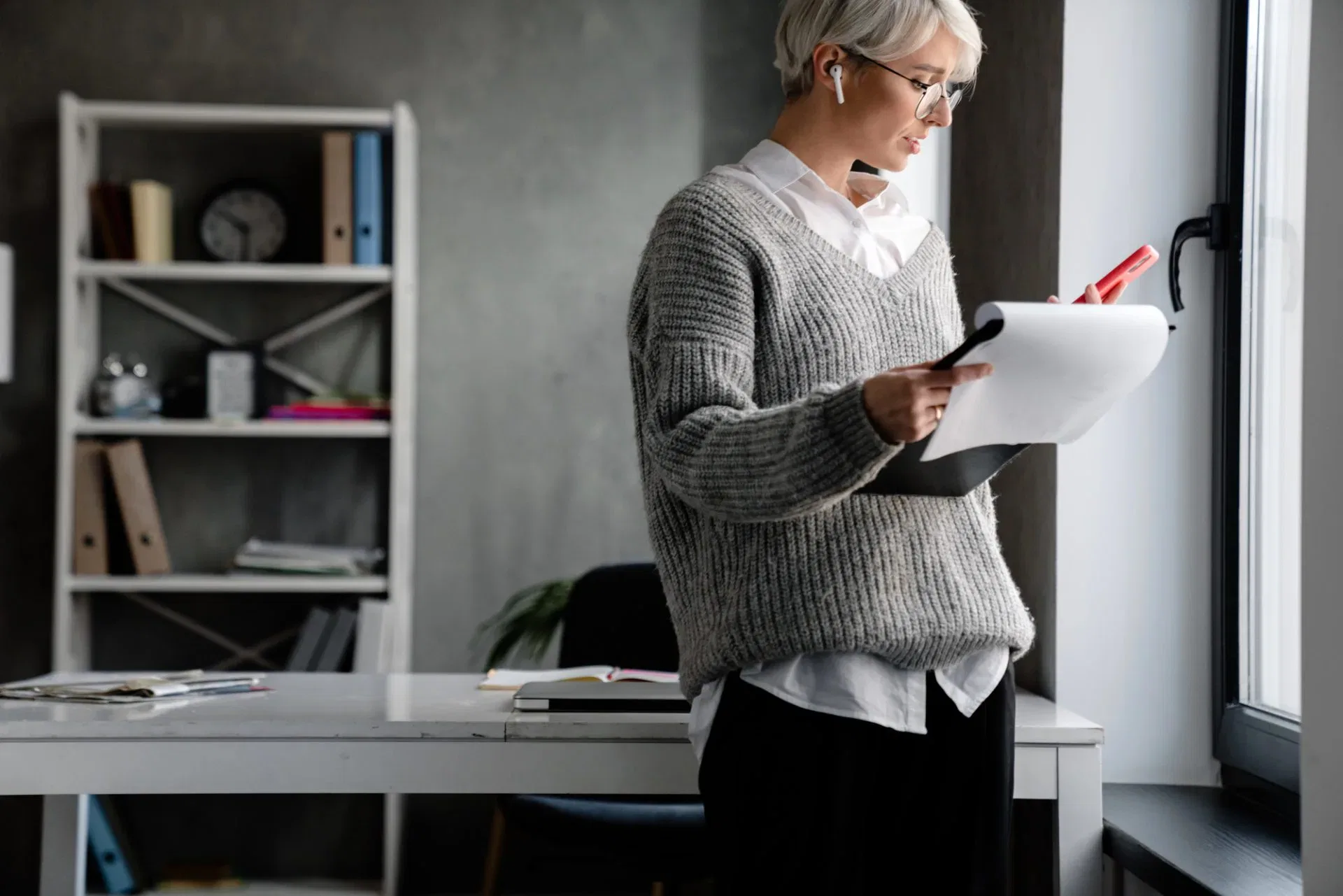 Person reviewing legal documents and notes while preparing to challenge or contest a will during a legal consultation.