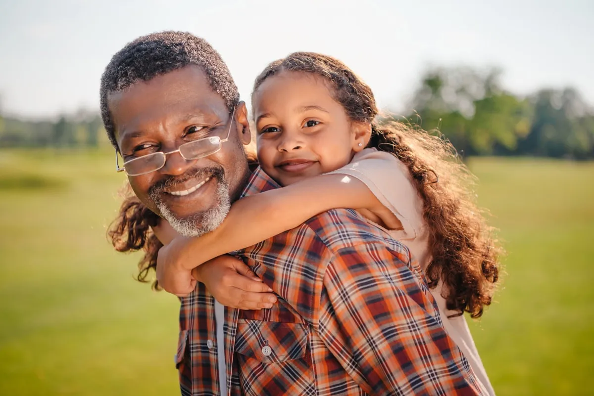 photo of a grandfather and his granddaughter, who are hoping to reunite in Canada with the help of Edmonton Law Office and their skilled immigration lawyers